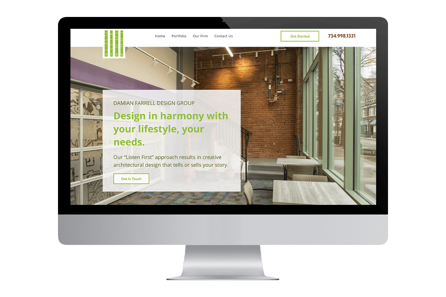 a computer monitor displays a website for damian farrell design group