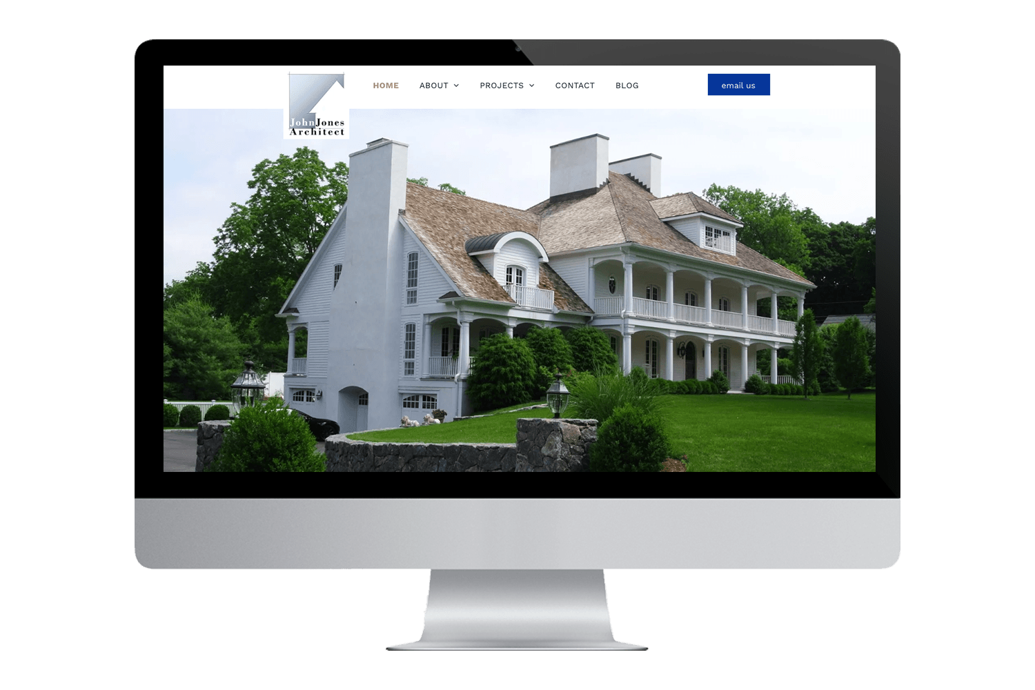 a computer monitor displays a website for john jones architect