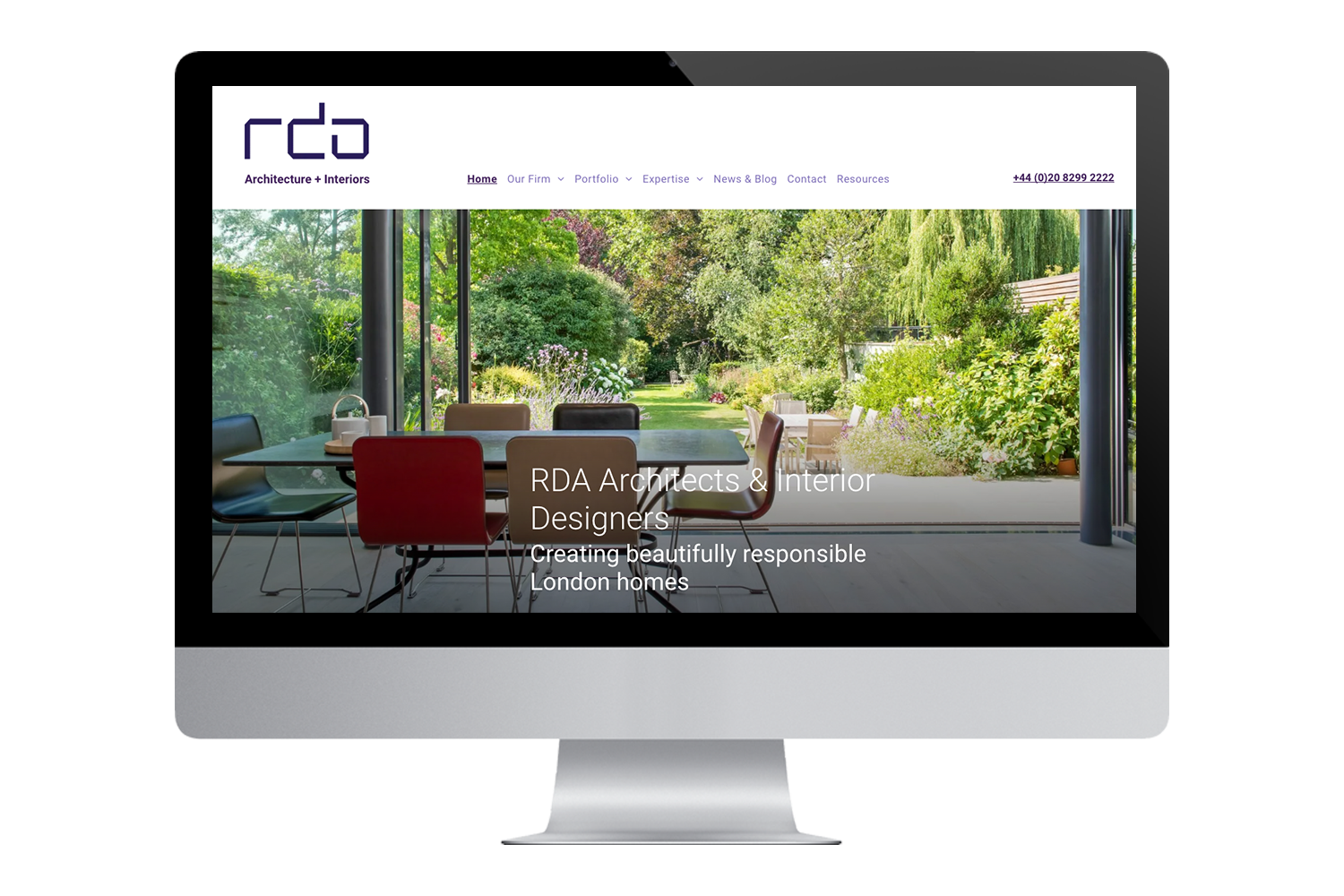 a computer monitor displays a website for rda architects and interior designers