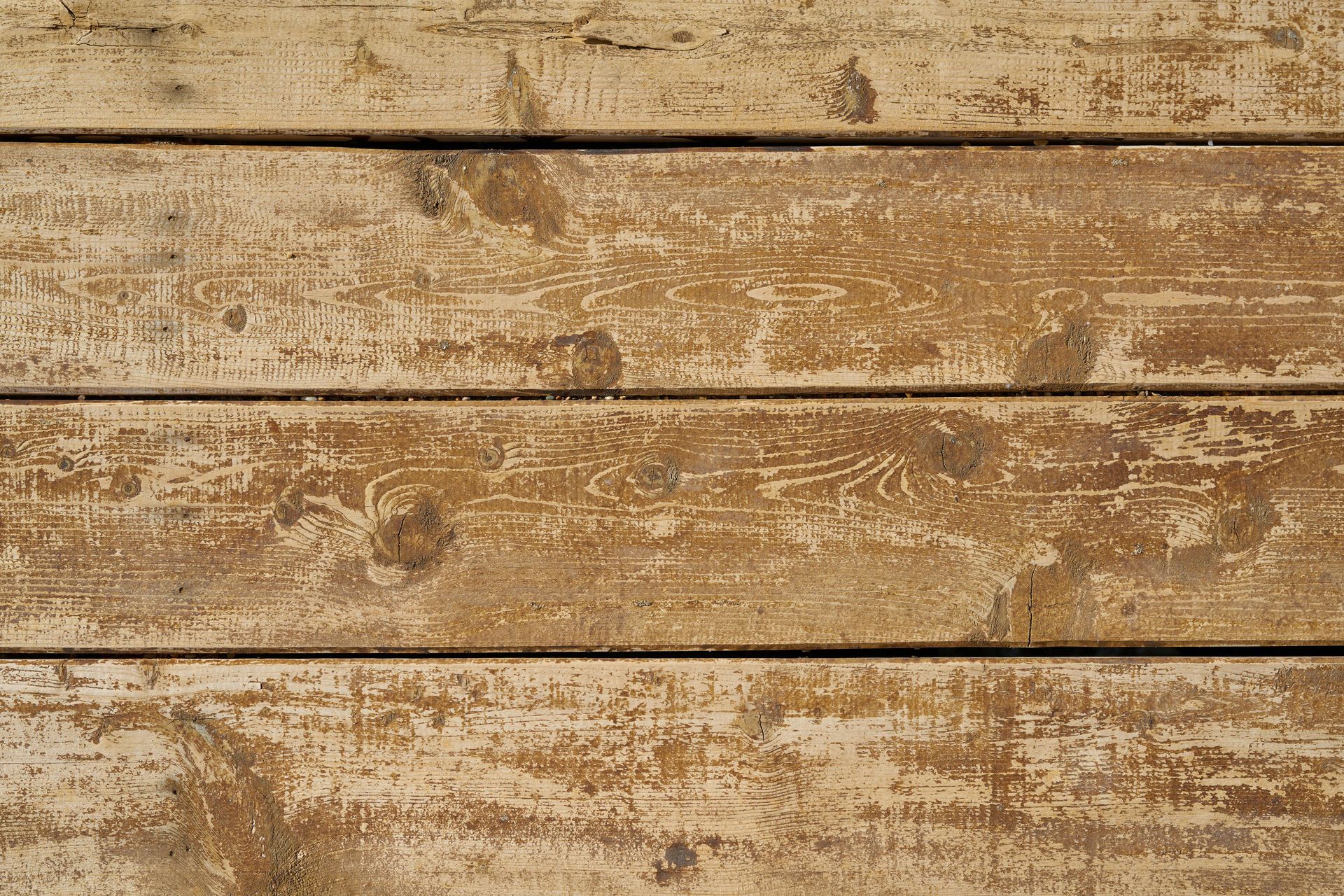 A close up of a wooden surface with peeling paint.