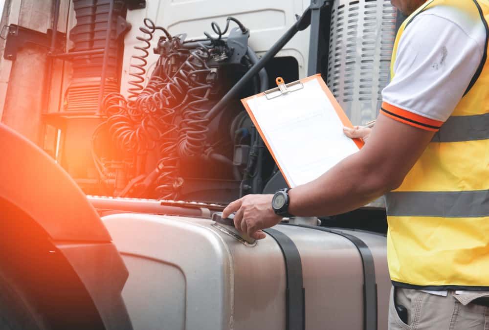 A Man in a Yellow Vest is in Front of a Truck — Wards Byron Shire Truck & Machinery Centre In Tyagarah, NSW