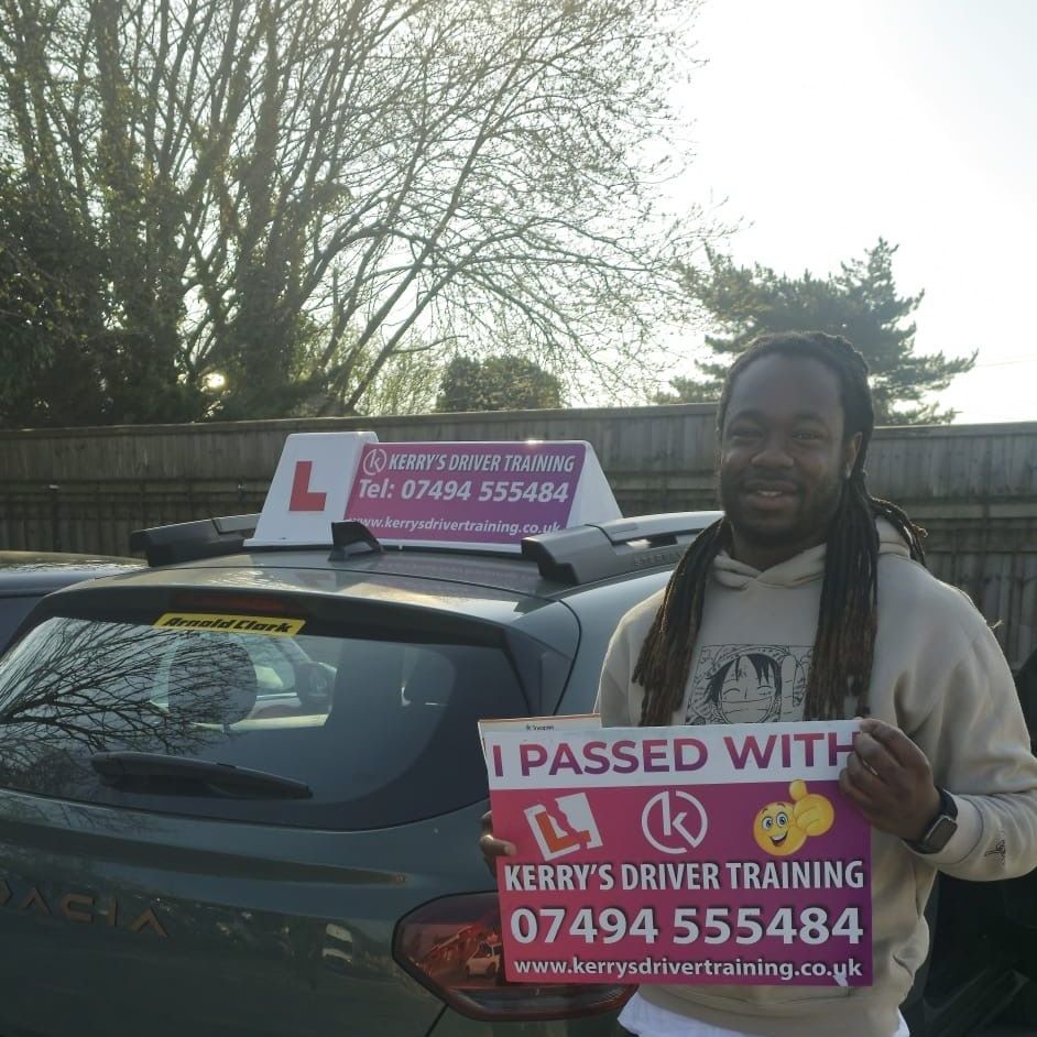 A man is holding a sign in front of a car.