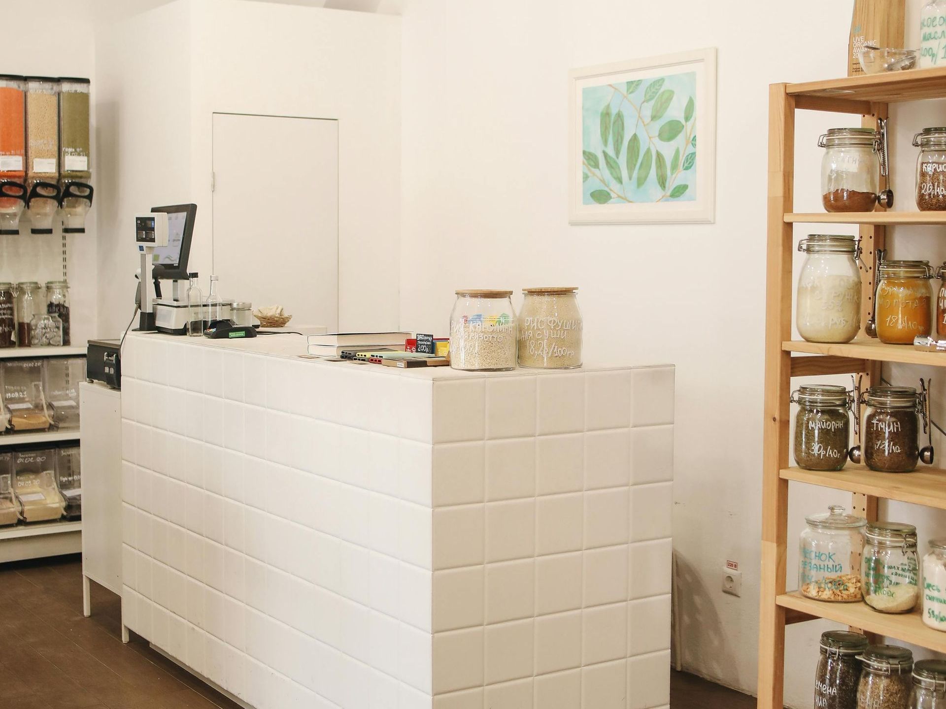 There is a counter in the middle of the room with jars on it.