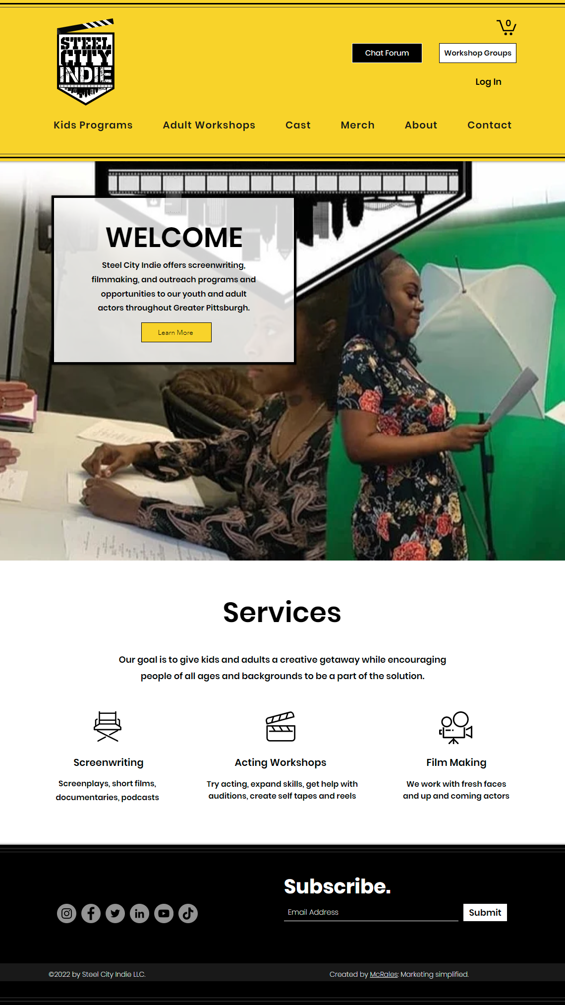 A woman is giving a speech in front of a green screen on a website.