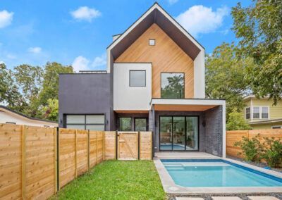 a modern house with a swimming pool in the backyard .