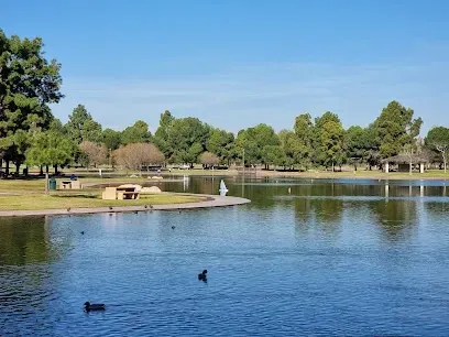 Sunlit meadows and shady groves at El Dorado East Regional Park, with families picnicking under clear blue skies
