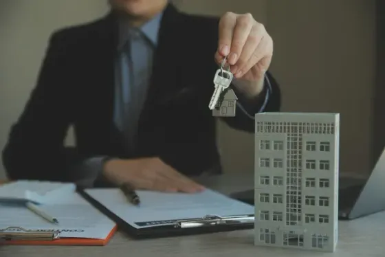Hard Money Lender Los Angeles - a real estate transaction where a professional is holding a set of keys, symbolizing property ownership or rental agreements.
