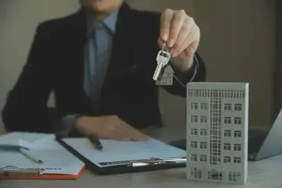 Hard Money Lender Los Angeles - a real estate transaction where a professional is holding a set of keys, symbolizing property ownership or rental agreements.
