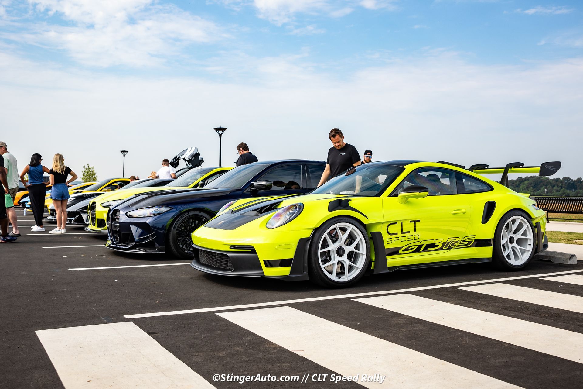 A row of cars are parked in a parking lot