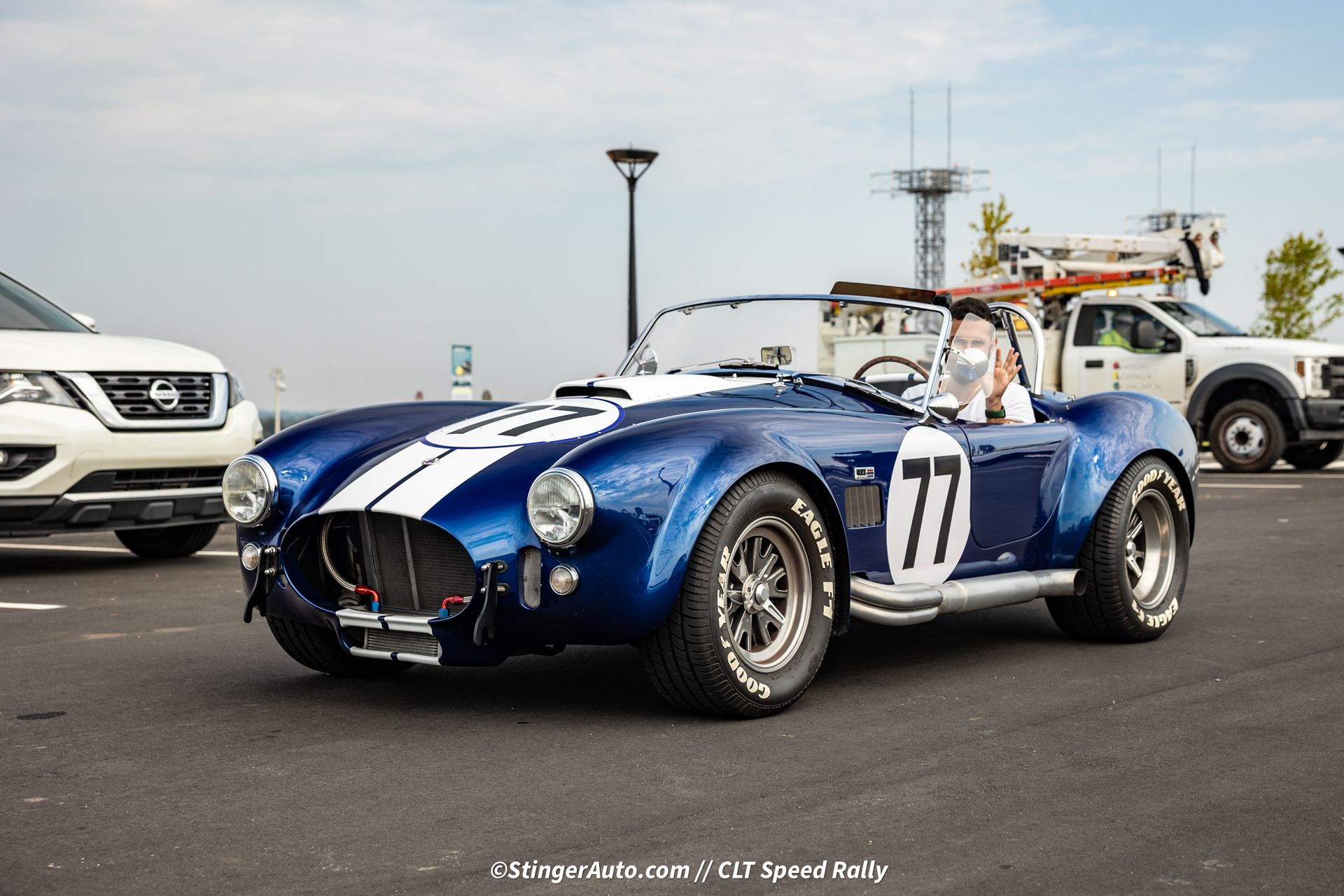 A blue sports car with the number 77 on the side