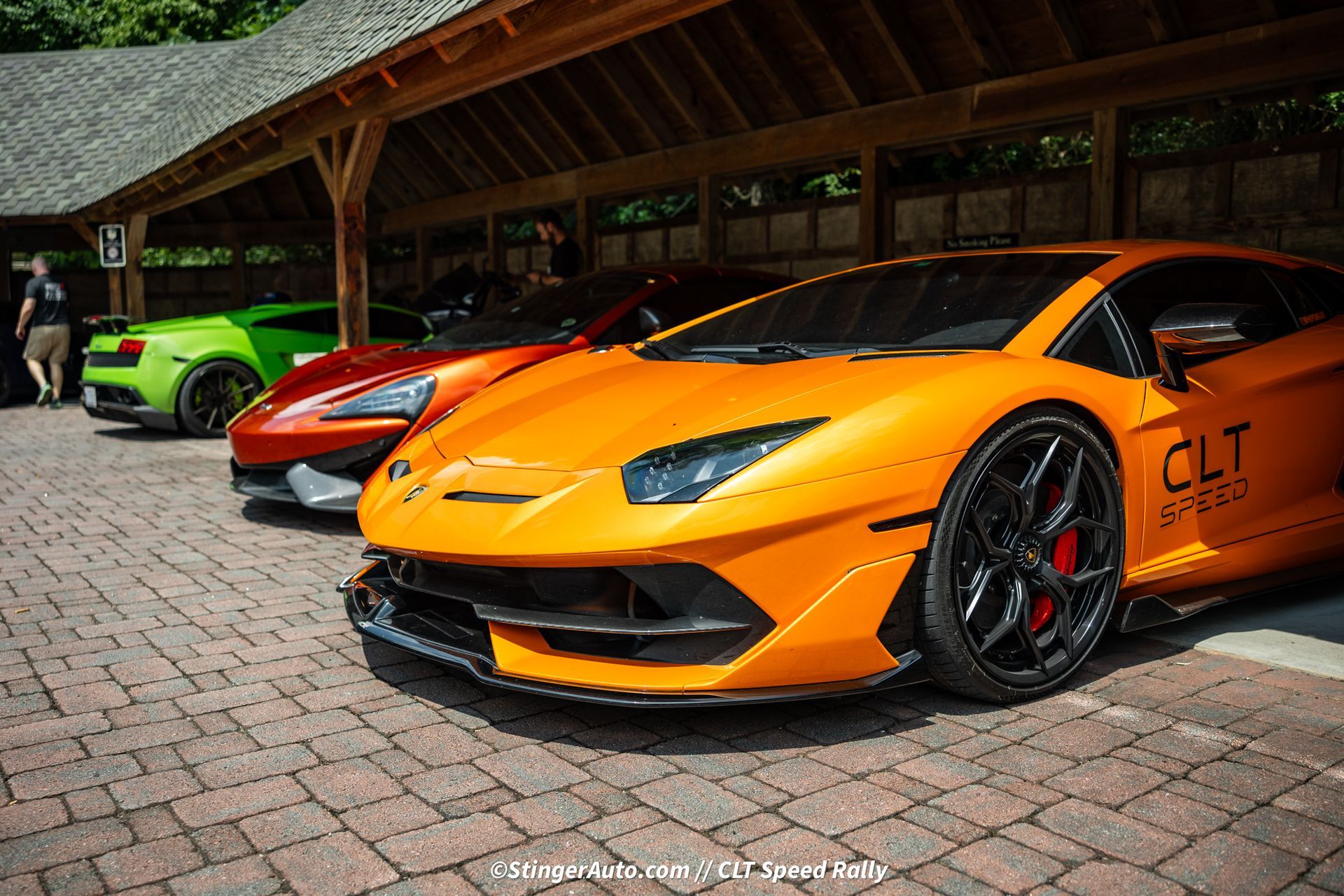 A row of lamborghinis are parked in a garage