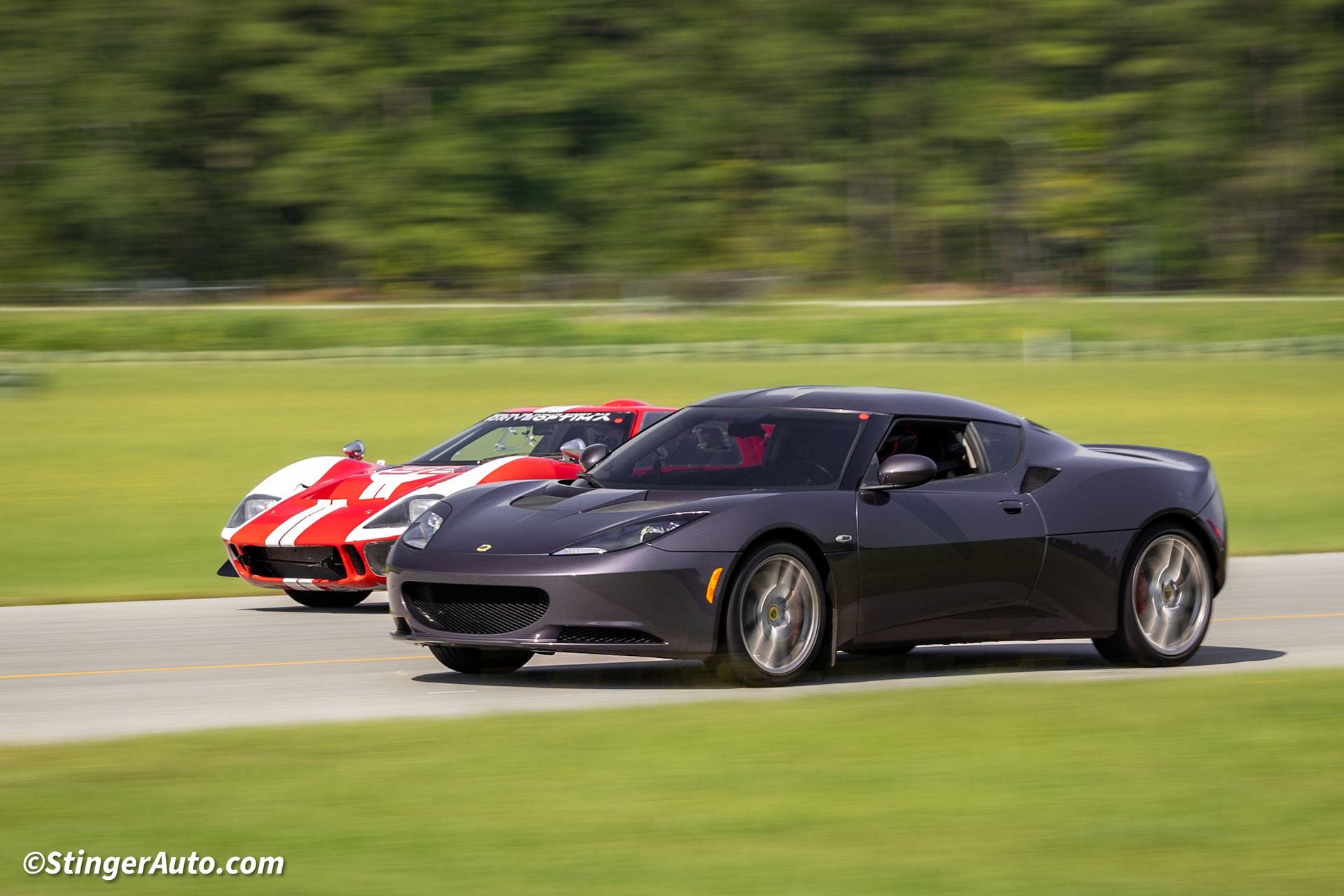 Two sports cars are racing on a track