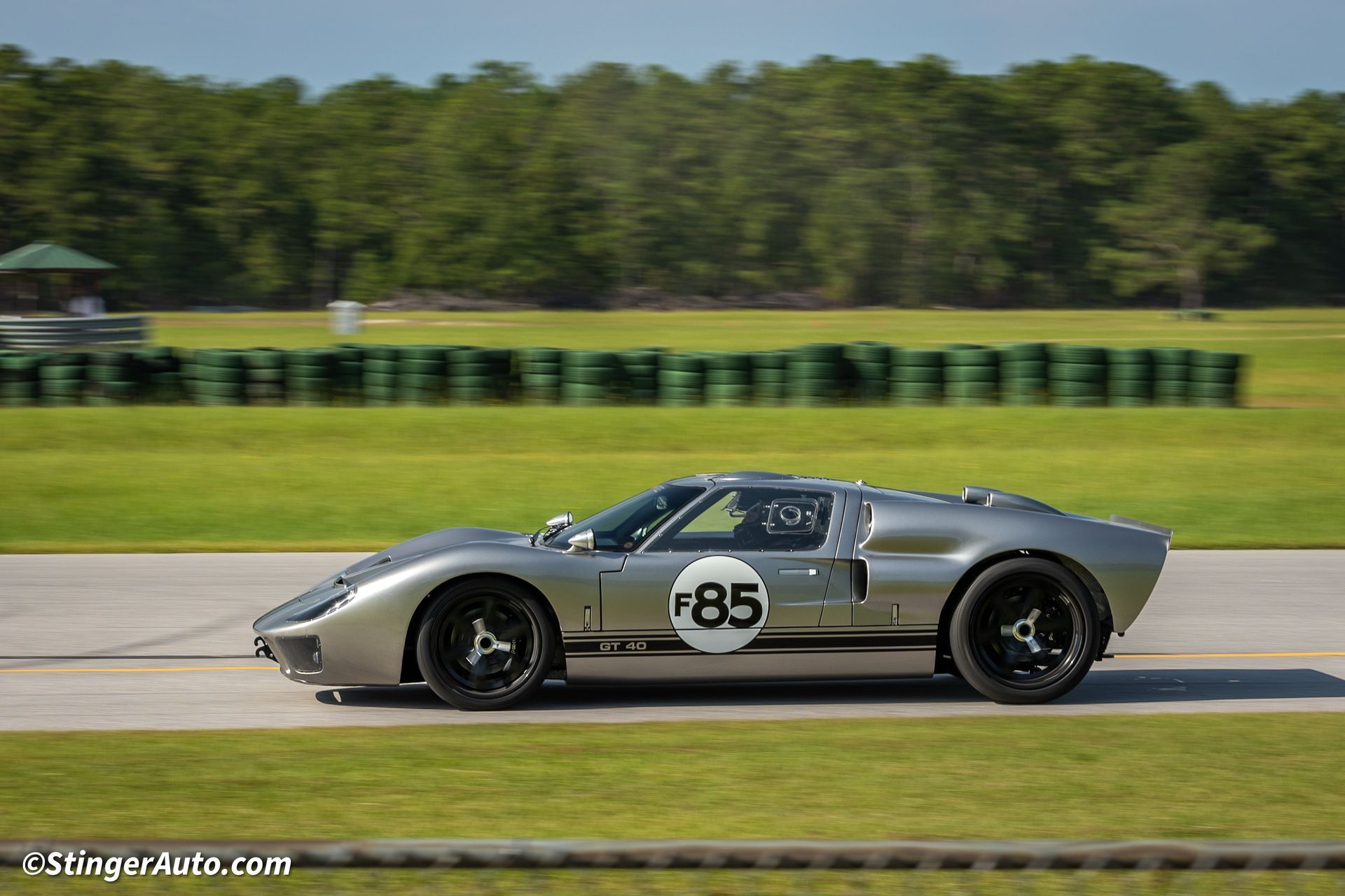 A silver sports car with the number 85 on the side