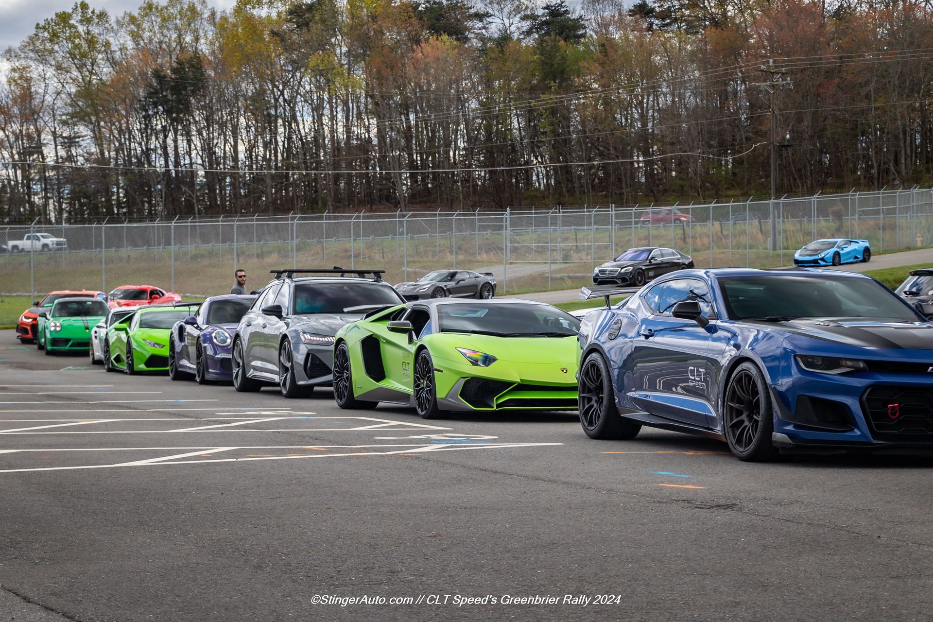 A row of sports cars are lined up in a row