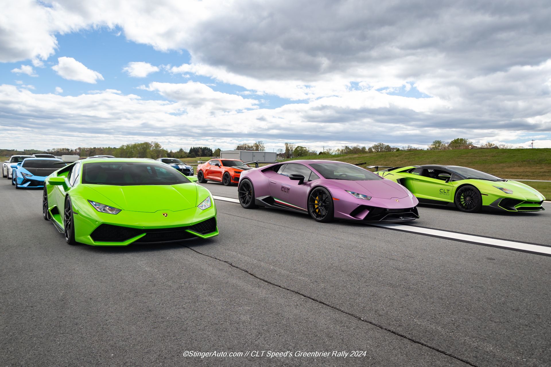 A row of lamborghinis are lined up on a runway