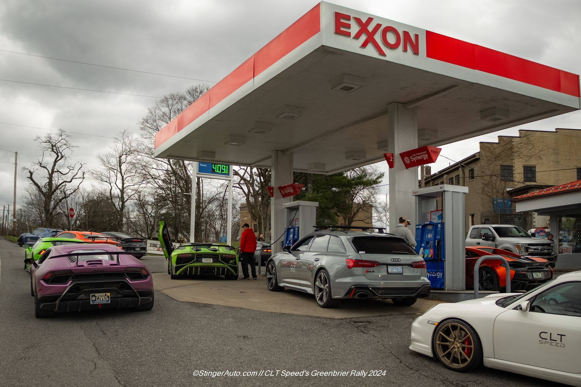 Cars are parked in front of an exxon gas station