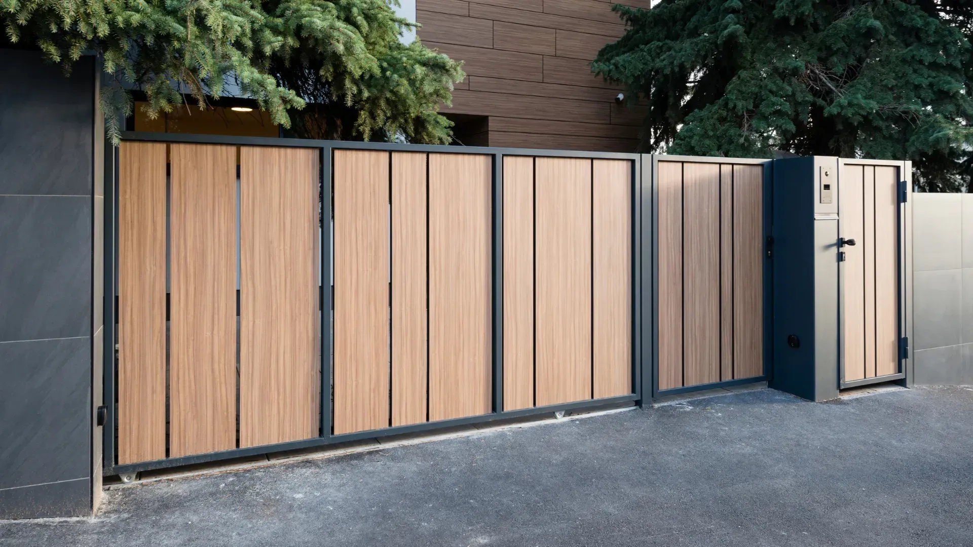Wooden gate with black frame, leading to a home.