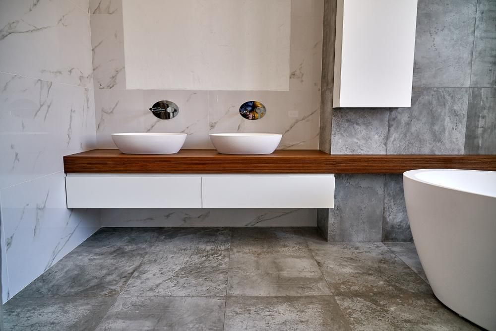 A Clean Bathroom with Two Sinks and A Bathtub — Peninsula Tiles in Umina Beach, NSW