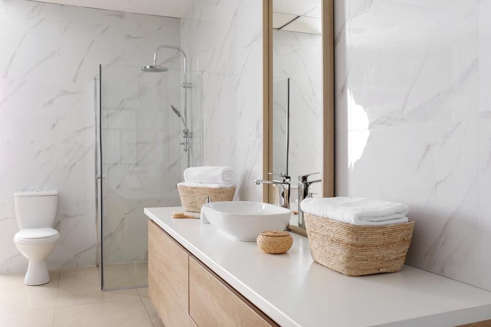 A Bathroom with Two Sinks, a Toilet, and A Shower — Peninsula Tiles in Umina Beach, NSW