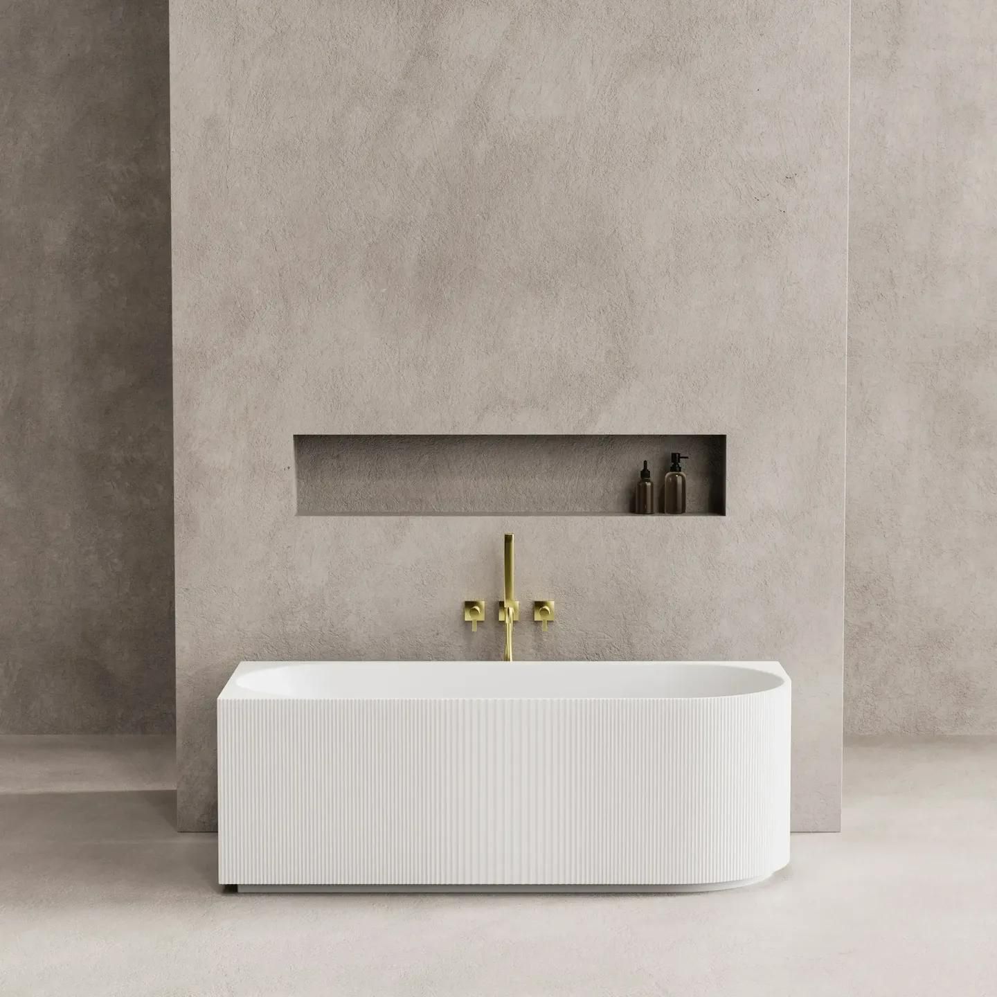 A white bathtub is sitting in a bathroom next to a wall.