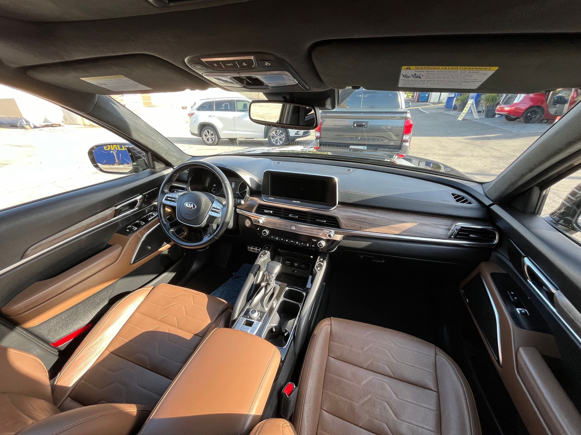 The interior of a car with brown leather seats and a steering wheel