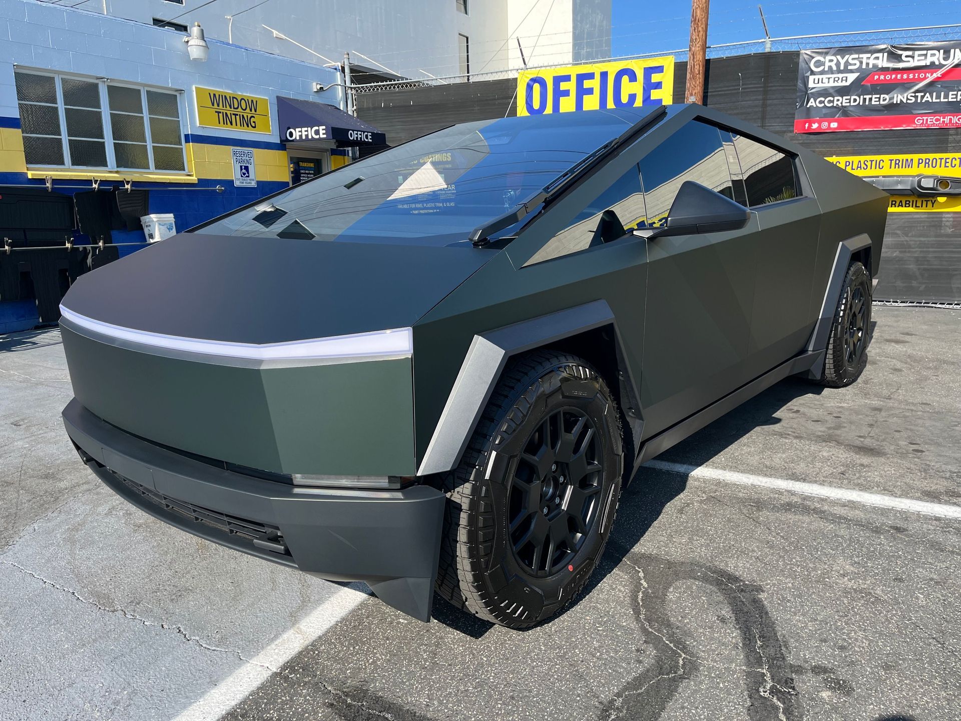 A tesla cybertruck is parked in a parking lot.