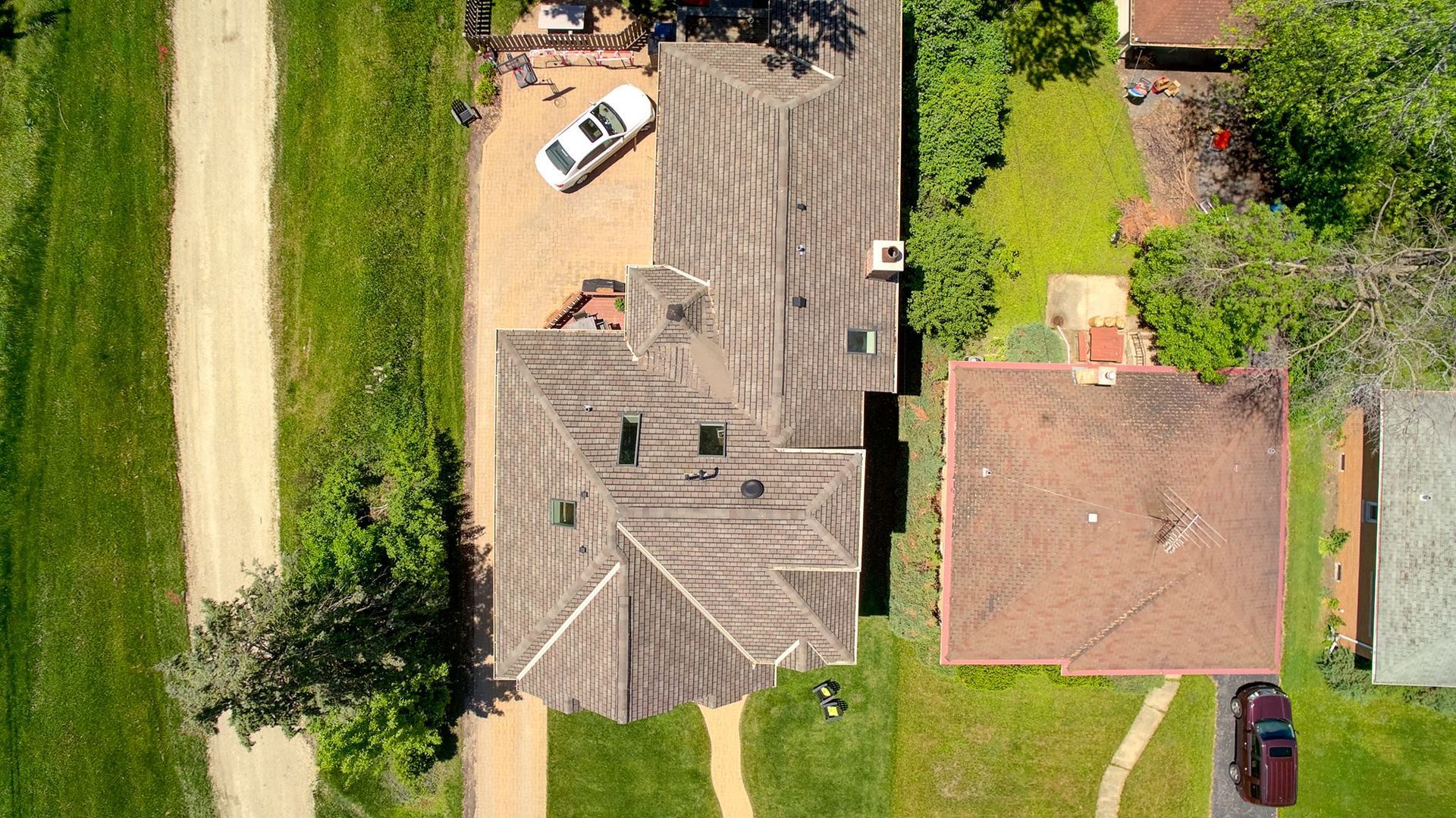 An aerial view of a house with a car parked in front of it.