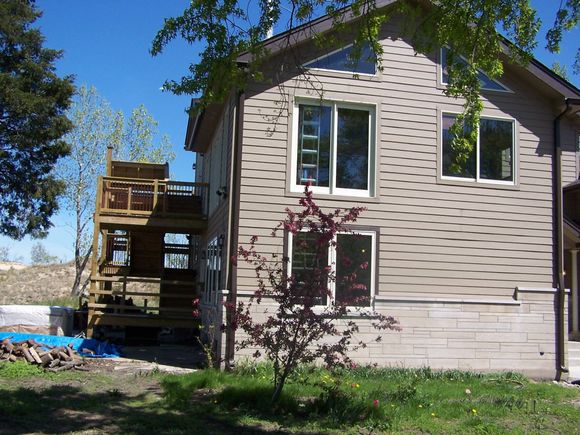 A house with a lot of windows and a deck