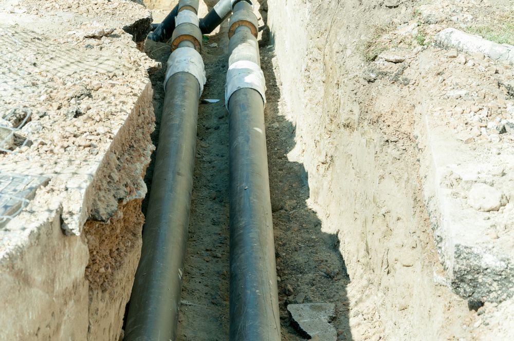 Two Pipes Are Connected to Each Other in a Trench — Hoges Plumbing In Kiama, NSW