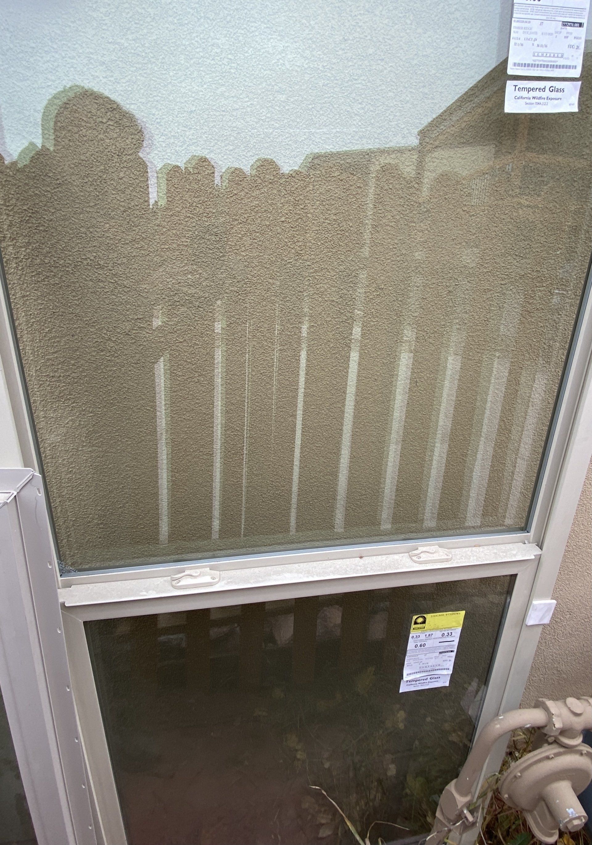 A window with a shadow of a fence on it.