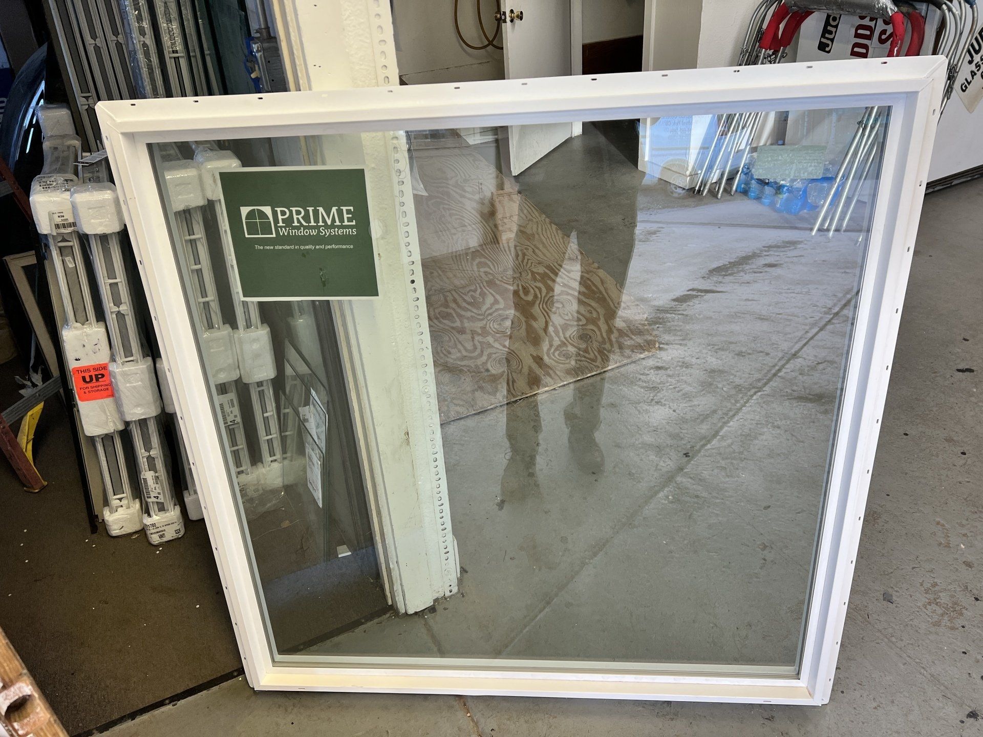 A white window with a green sign that says prime on it