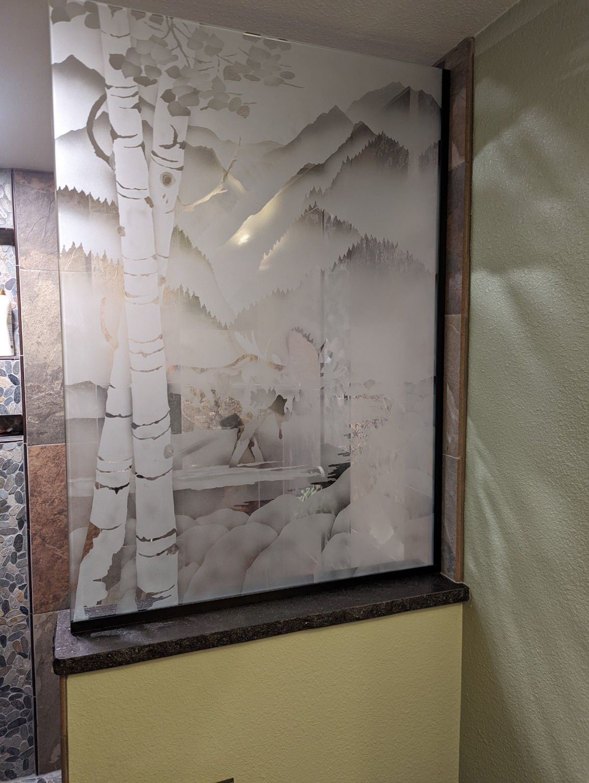 A wall with a picture of trees and mountains on it