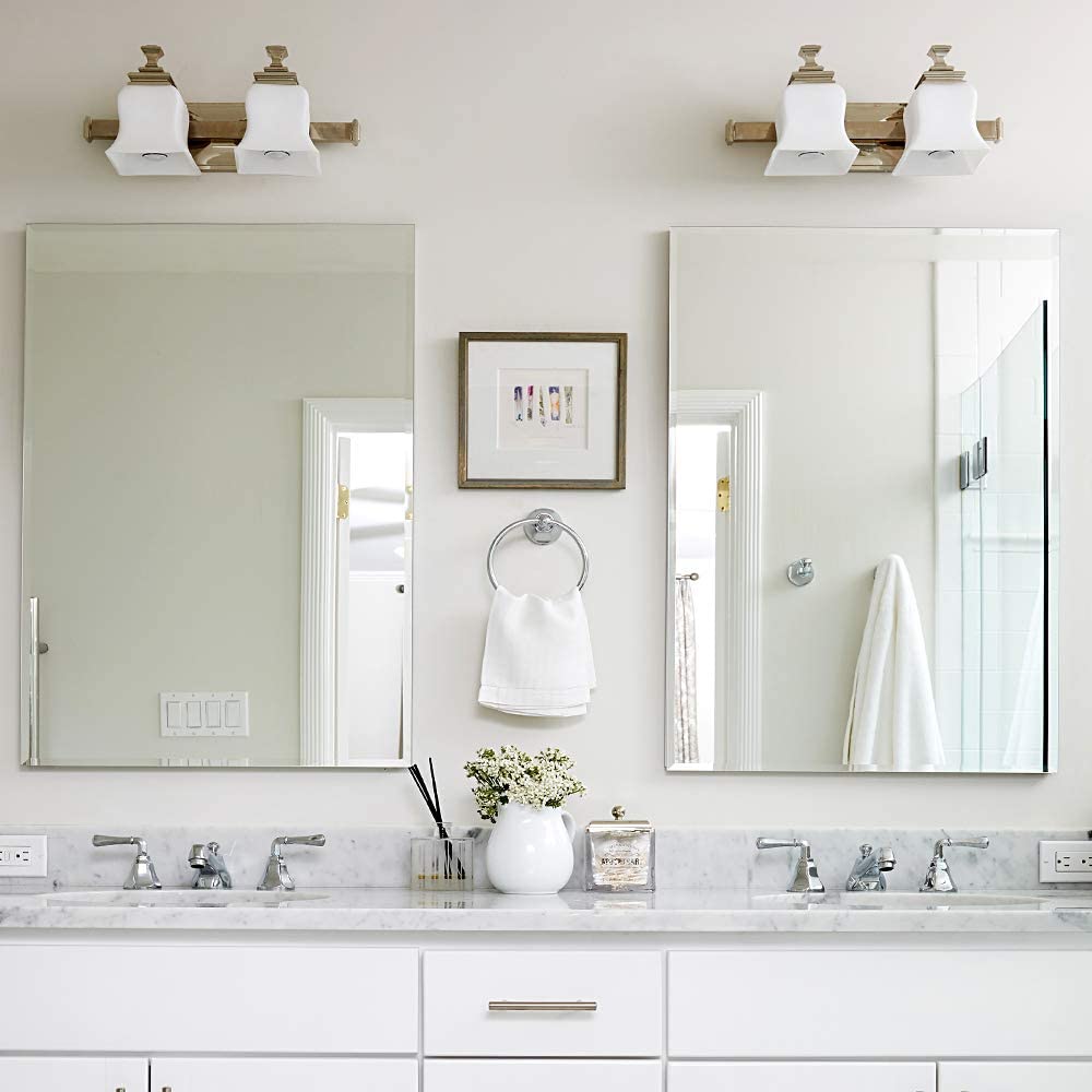 A bathroom with two sinks and a large mirror