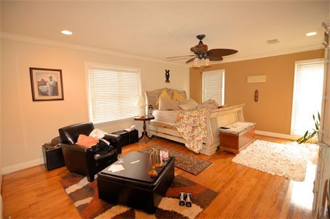 Bedroom with hardwood flooring and ceiling fan