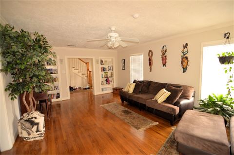 Living area with a couch and a ceiling fan