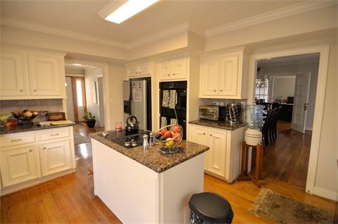Kitchen with hardwood flooring and two ovens