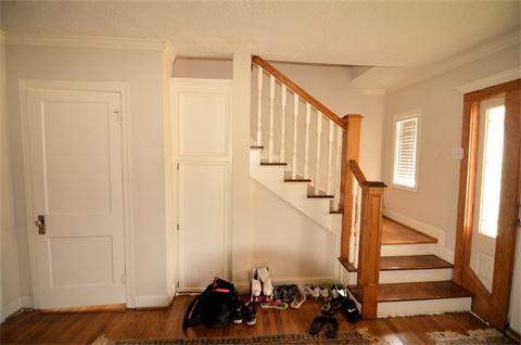 Entry way with wooden stair case leading upstairs