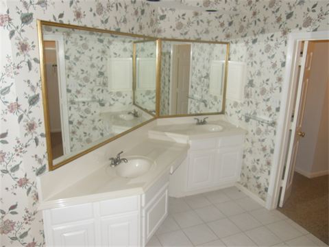 Bathroom vanity with two sinks and wallpaper