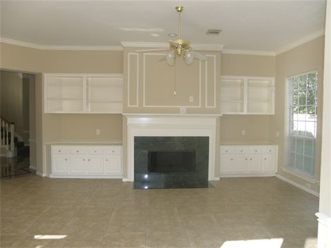 Fireplace in room with ceiling fan