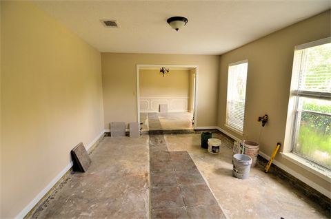 Room with flooring pulled up, under construction