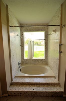 Round tub in shower area