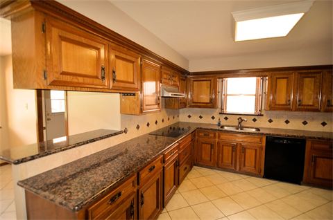 Kitchen with finished wood cabinets