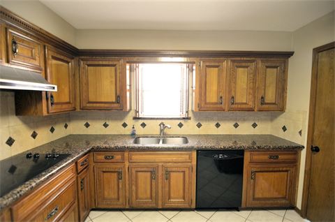 Kitchen with finished wood cabinets