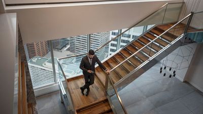 man in commercial building standing on stairs