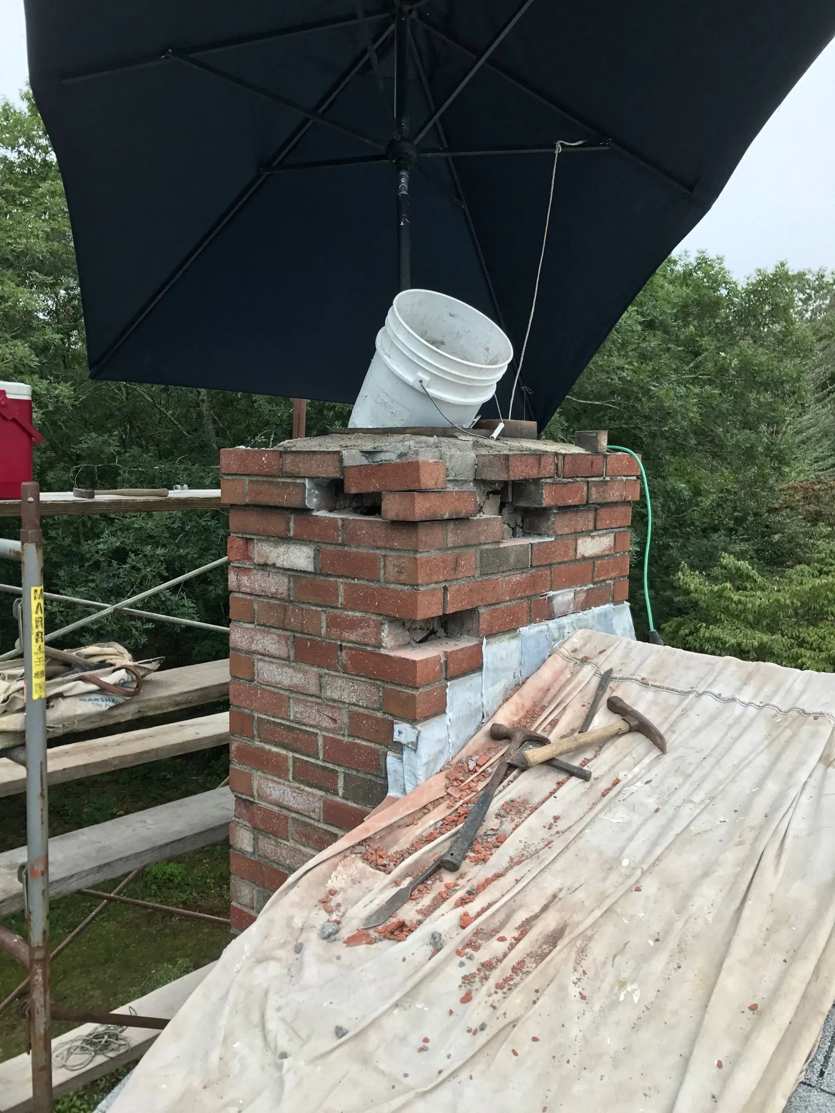 A chimney made of bricks is being installed.