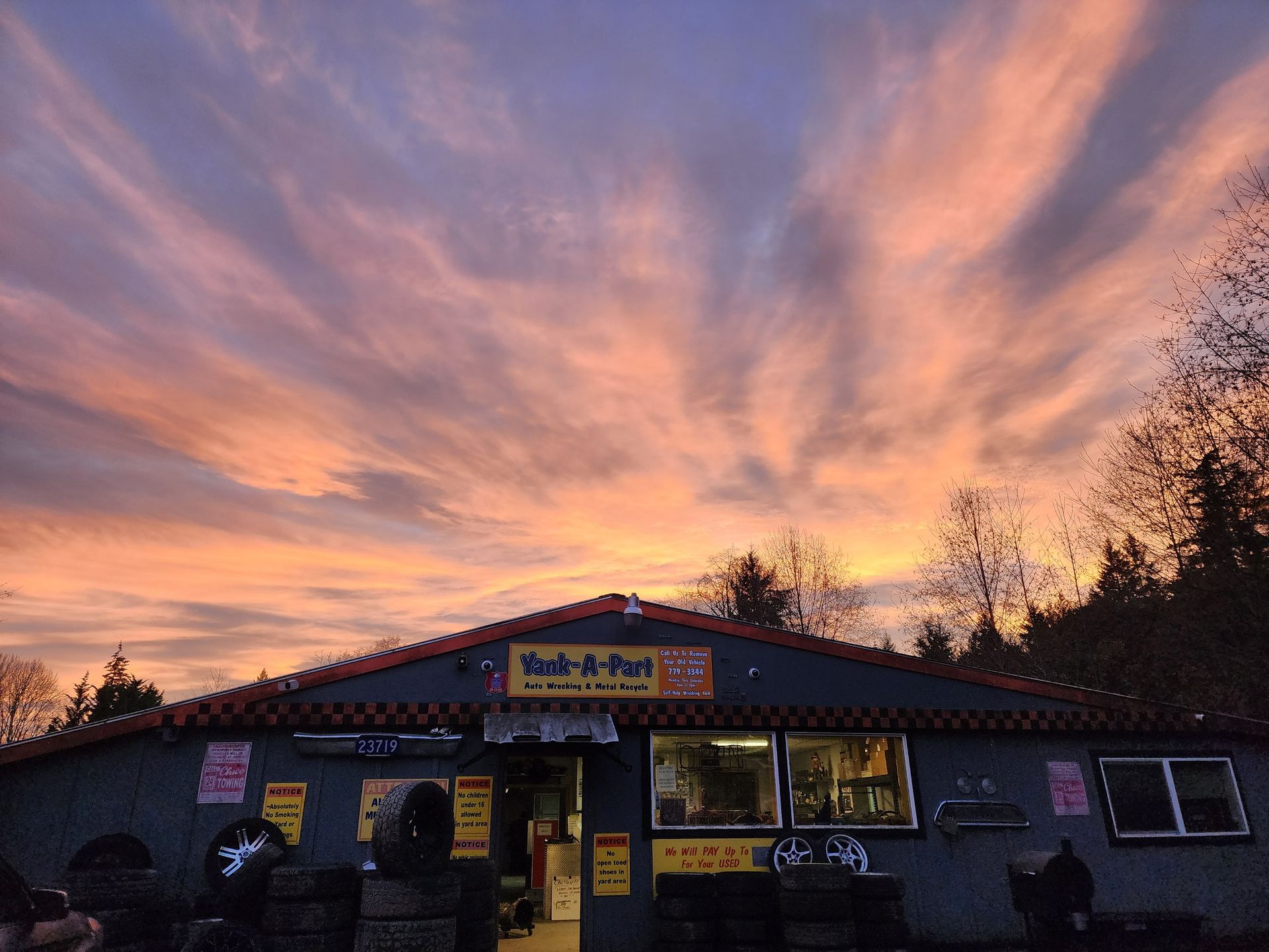Restaurant with sunset sky; orange and pink clouds above the building.