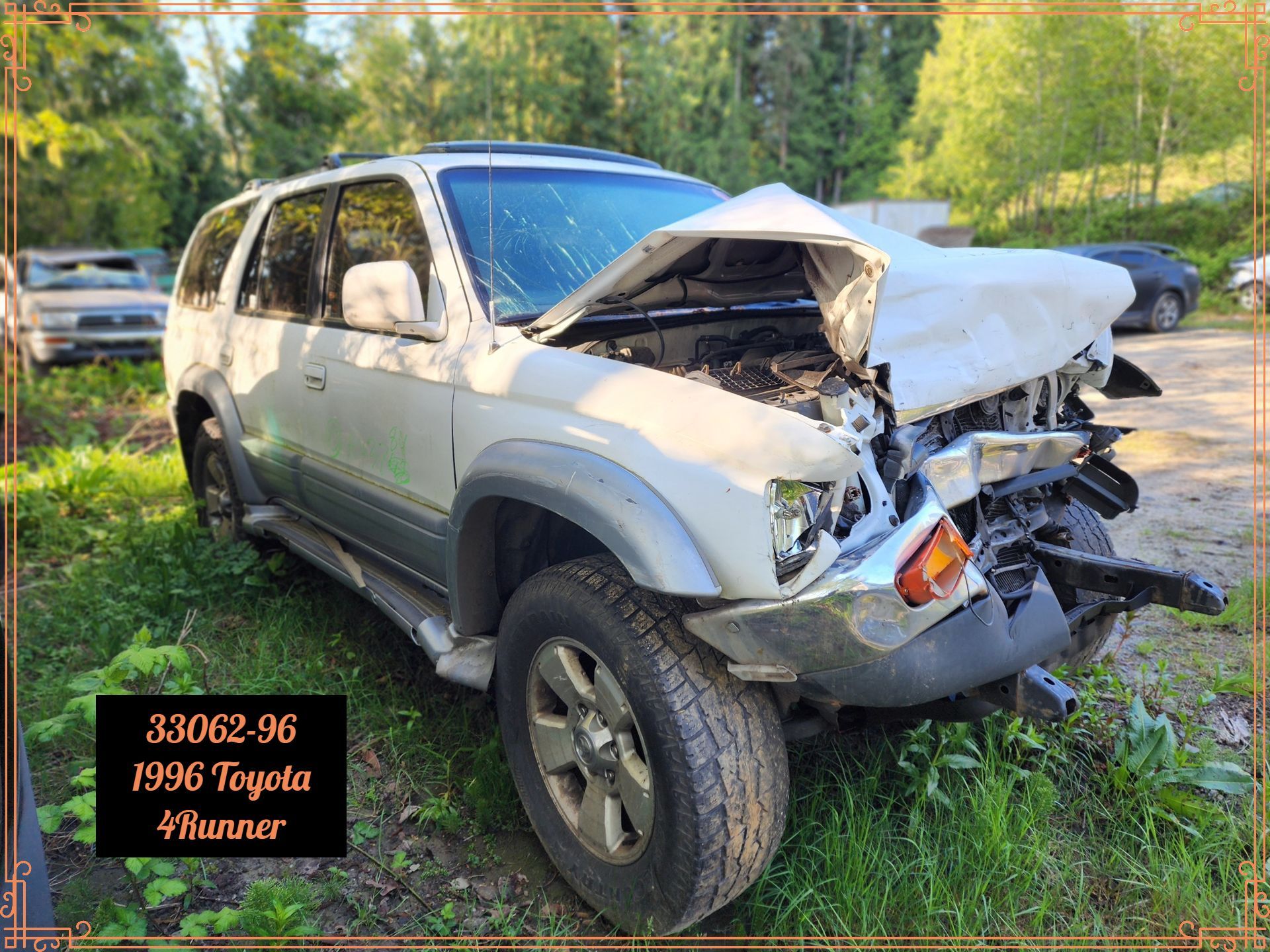 Damaged 1996 Toyota 4Runner with severe front-end damage; parked in a grassy area.