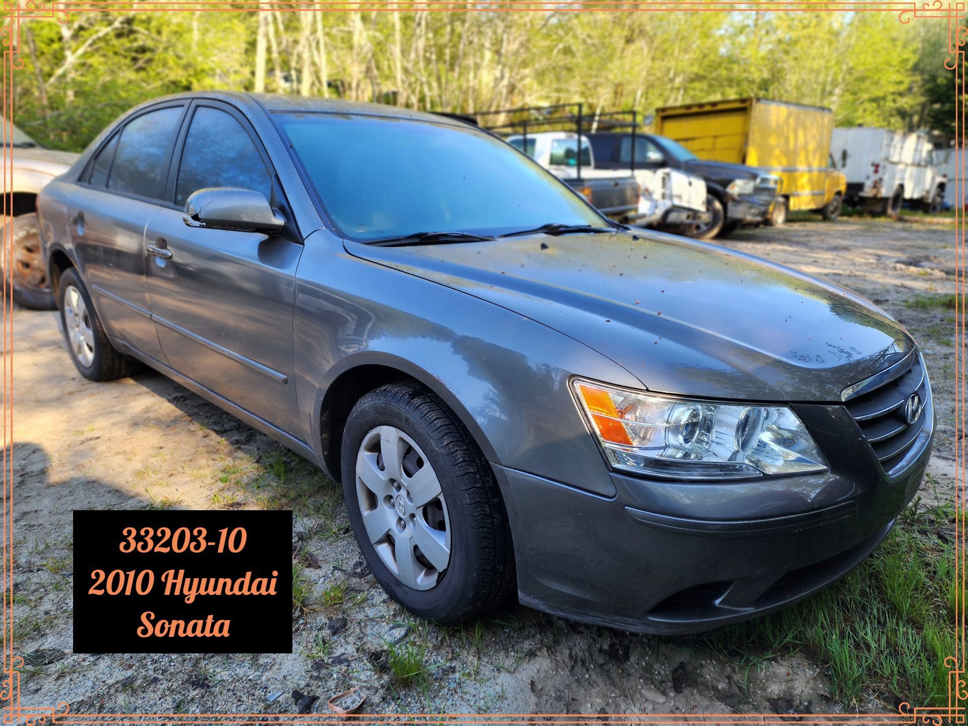 2010 gray Hyundai Sonata parked outside. Text on a box reads 