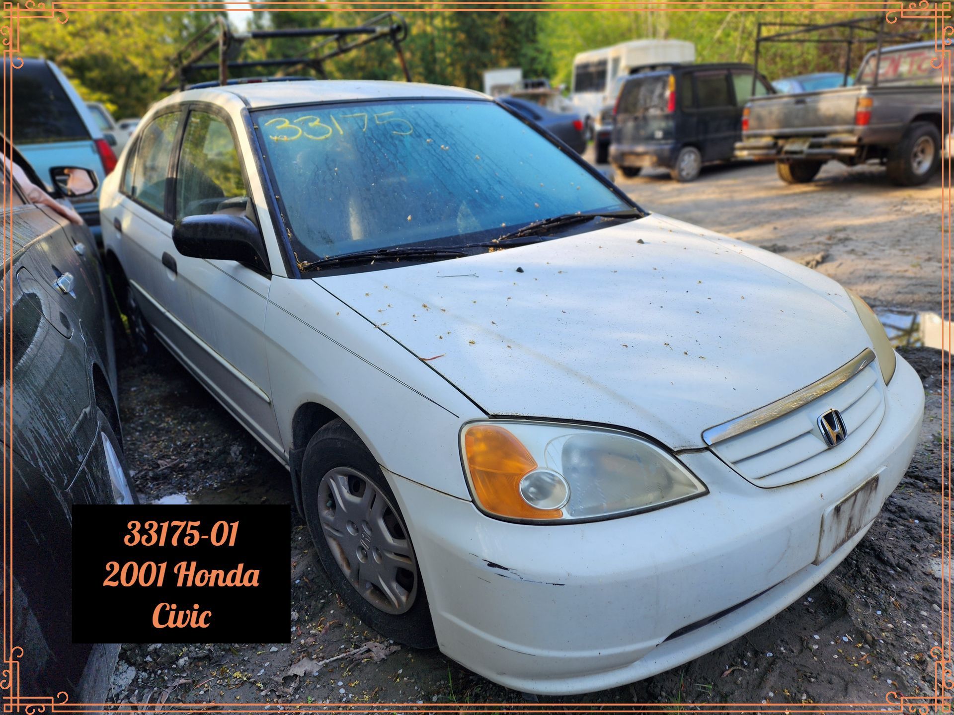 White 2001 Honda Civic in a salvage yard, with visible damage.