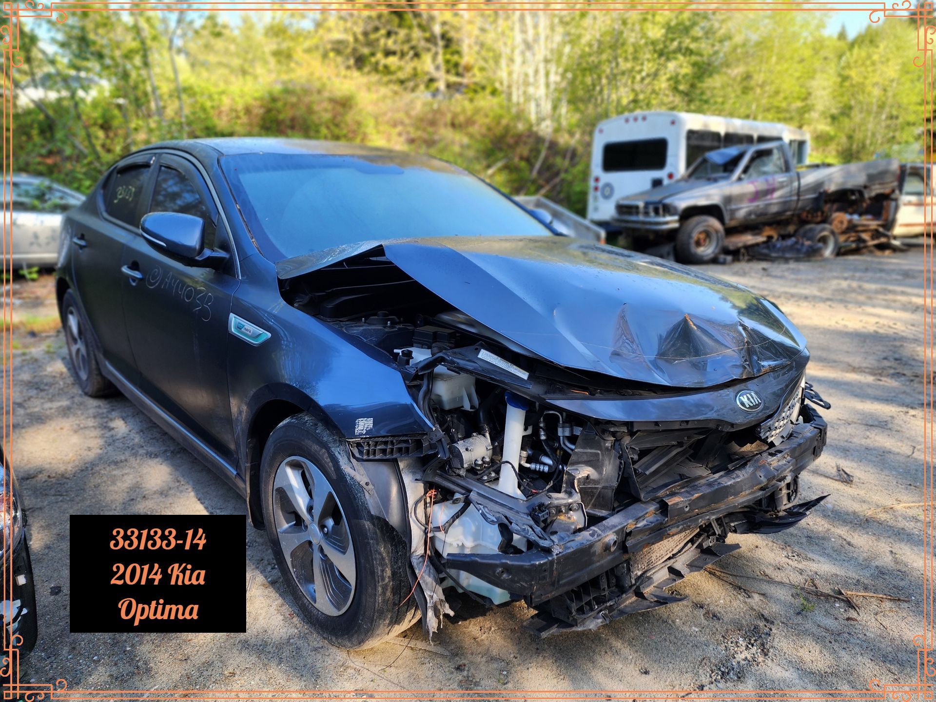Damaged dark blue 2014 Kia Optima with front-end collision damage in a salvage yard.